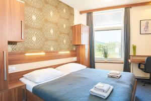 Postel nebo postele na pokoji v ubytování Wellness Hotel Kocanda