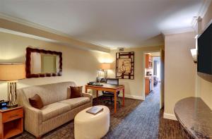 a living room with a couch and a table at Eden Resort and Suites, BW Premier Collection in Lancaster