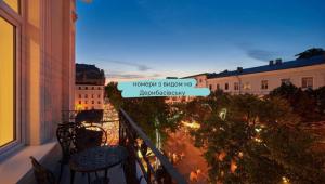 a balcony with a view of a city at night at Radisson Hotel City Centre Odesa in Odesa