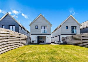 a house with a fence in front of a yard at Kieton Sands - Croyde in Croyde