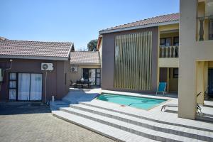 uma casa com piscina num pátio em Protea Guesthouse em Newcastle