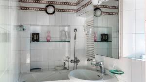 a bathroom with a sink and a mirror and a tub at TORRE GRIMALDI 2&2, Emma Villas in Ventimiglia
