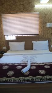 a bedroom with a bed with a pillow on it at BLUE MARINE BEACH REOSRT in Baga