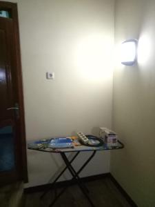 a table in a room with a phone on it at Bito Homestay 