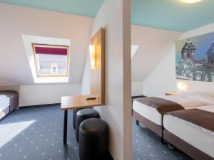 Postel nebo postele na pokoji v ubytování B&B Hotel Nürnberg-City