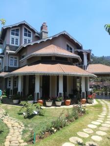 a large house with a pathway in front of it at Royal Wattles in Nuwara Eliya