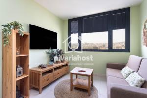 a living room with a couch and a tv at The Mint Santa Cruz, by Nivariahost in Santa Cruz de Tenerife