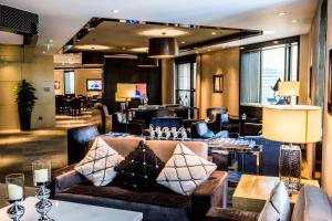 a hotel lobby with a couch and a bar at Courtyard By Marriott Shanghai Pudong in Shanghai
