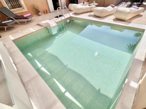 a swimming pool with blue water in a house at Luxury Villa Azur Natura with private pool by DadoVillas in Spartýlas