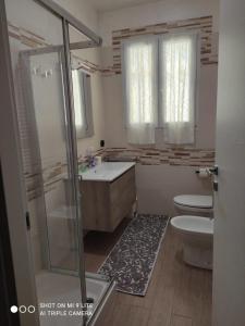 a bathroom with a shower and a sink and a toilet at Da Francesca in Scardovari