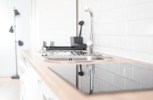 a bathroom sink with a faucet on a counter at Apartamento Balbín IV in Gijón
