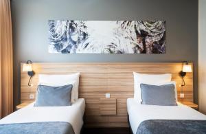 Posteľ alebo postele v izbe v ubytovaní Leonardo Hotel Vienna Hauptbahnhof