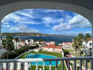 a view from the balcony of a resort with a swimming pool at Apartamentos El Bergantin Menorca Club in Fornells