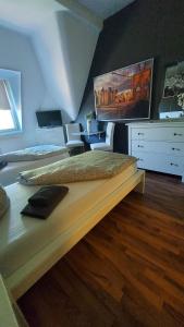 a bedroom with a bed with a tv on the wall at Villa Meuselwitz in Meuselwitz