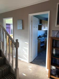 a hallway with a door leading to a kitchen at Number One - Fully Equipped Self Catering Four Bedroom House next to Dunedin, 15 mins to Spurn, 20 mins to Saltend, 12 mins to Easington in Patrington