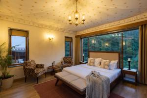 a bedroom with a bed and a large window at SaffronStays Moringa Valley - Oak Villa in Udaipur +61 photos