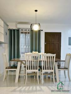 a dining room with a table and chairs at Ana's Haven Transient Olongapo Subic 2 East Bajac-Bajac in Olongapo