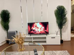 a living room with a tv on a white entertainment center at Cosy Appartement in elberfeld in Wuppertal