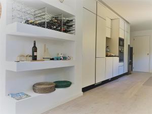 a room with white walls and shelves with wine bottles at Fashion Villa in Vilamoura with Private Pool in Quarteira