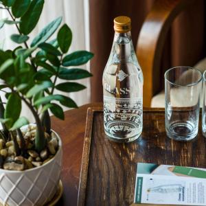 Eco Green Boutique Hotel Da Nang في دا نانغ: زجاجة مياه وكأس على طاولة