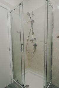 a shower with a glass enclosure in a bathroom at City Center - Casa luxury in Ravenna