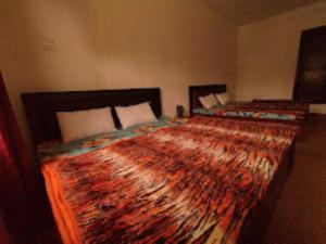 two beds in a room with two at Hotel City Way, Srinagar in Srinagar
