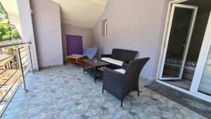 a patio with chairs and a table on a balcony at Apartment Harmony in Višegrad