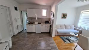 a living room with a couch and a kitchen at Apartment Harmony in Višegrad