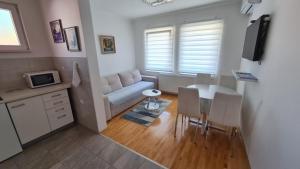 a small living room with a table and a couch at Apartment Harmony in Višegrad