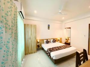 a hotel room with a bed and a table at HOTEL THE CELEBRATION BY AMOD Best Hotel & Rooftop in Udaipur