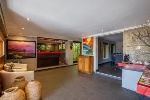 a living room with a counter and a lobby at Hog Hollow Country Lodge in The Crags