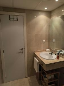 a bathroom with a sink and a large mirror at Balay Apartment Benidorm in Benidorm +15 photos