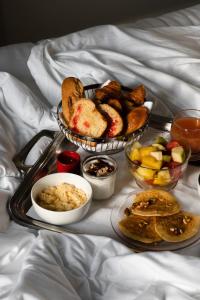 a tray of bread and other foods on a bed at Fourvi&egrave;re H&ocirc;tel in Lyon