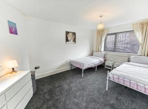 a bedroom with two beds and a window at Southdown Road close to Plymouth Argyle FC in Plymouth