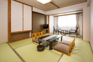 a room with a table and chairs and a dining room at Yumoto Noboribetsu in Noboribetsu