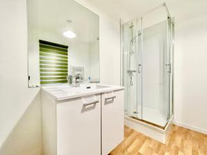a white bathroom with a shower and a sink at Appartsaintnazaire - Saint Nazaire - 5 Appartements - Centre Ville in Saint-Nazaire +69 photos