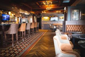 a bar with a bunch of chairs in a room at O'Neill Arms Hotel in Toome