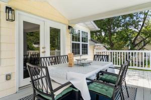 a porch with a table and chairs on a house at Amazing Chesapeake Views Family getaway 4brms in Chesapeake Beach