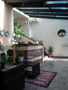 a lobby with a piano and potted plants at Sani Hotel in Tbilisi City