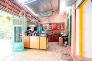 a kitchen with red cabinets and a blue door at Ha Noi Homestay in Hanoi