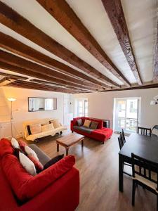 een woonkamer met twee rode banken en een tafel bij Charming two-room apartment near Montparnasse in Parijs