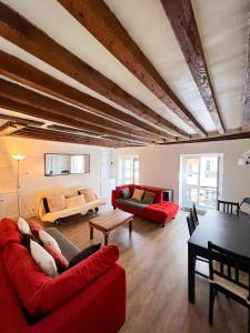 a living room with two red couches and a table at Charming two-room apartment near Montparnasse in Paris