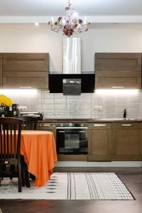 a kitchen with a table and a chandelier at Aray apartment in Almaty