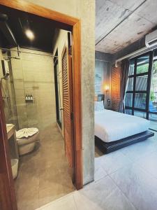 a bedroom with a bed and a shower and a toilet at Yotaka The Hostel in Bangkok +44 photos