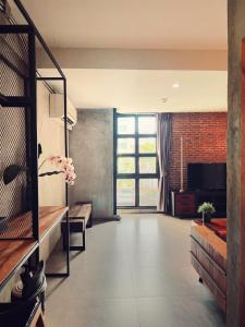 a large living room with a large window at Yotaka The Hostel in Bangkok