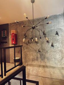 a chandelier hanging from a wall with ducks on it at Yotaka The Hostel in Bangkok