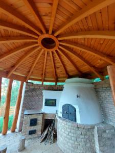 an outdoor kitchen with a large wooden roof at Vendégház Petörke in Bárdudvarnok