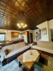 a large room with two beds and a table at Vradeto Guesthouse in Vradéton