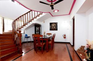 a dining room with a table and a ceiling fan at Villa Calangute Phase 4 in Calangute