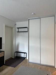 a sliding glass door in a room with a table at Studio Seaside in Tromsø